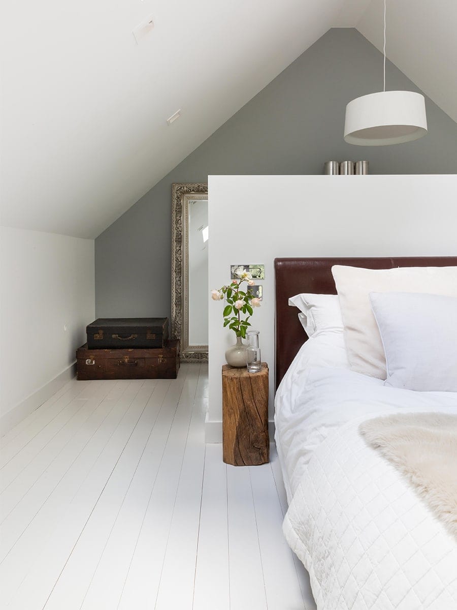 Cambray House loft bedroom with vaulted ceiling, white-painted floors and natural materials, Cotswolds